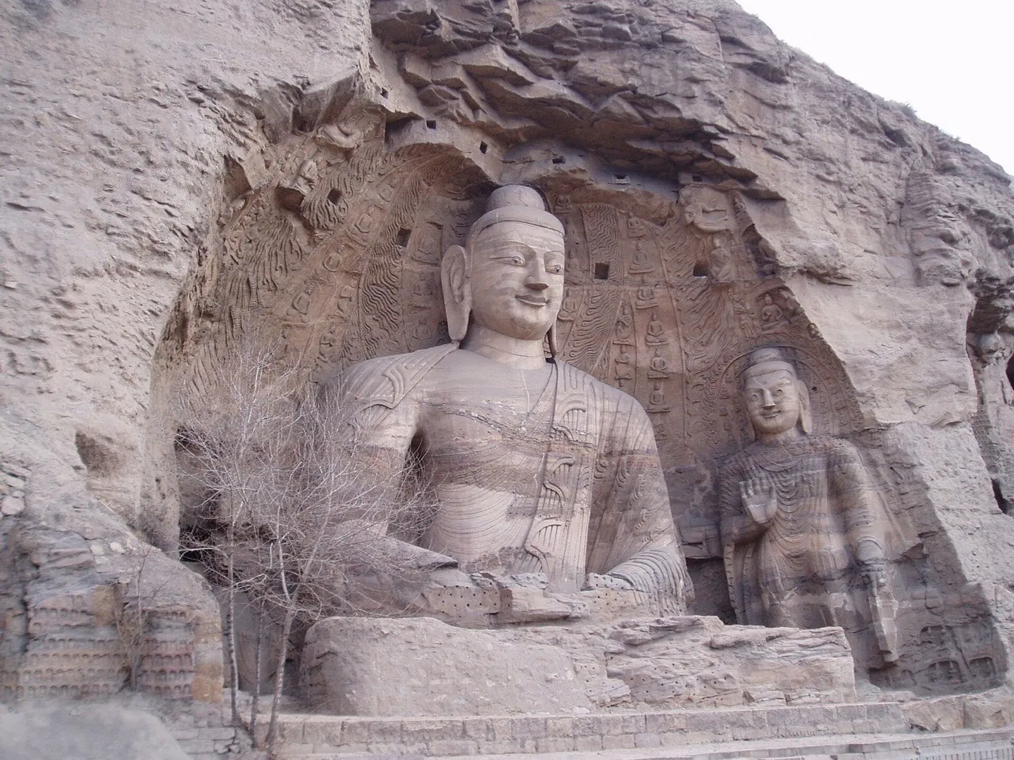 Ancient Buddha statues carved into a cliff at the Longmen Grottoes near Luoyang
