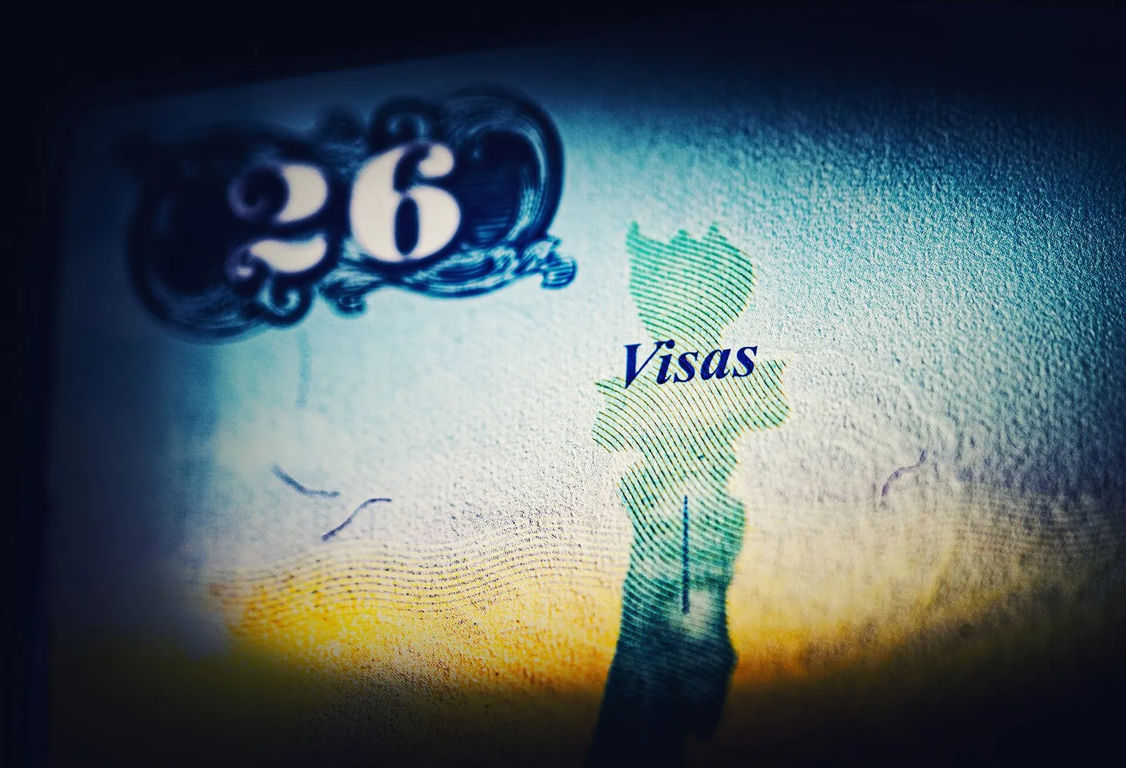 A passport with an approved Chinese visa sticker on a desk beside a printed application form