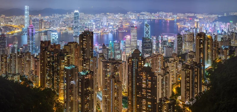 The Hong Kong Island skyline and Victoria Harbour seen from the Kowloon side at dusk