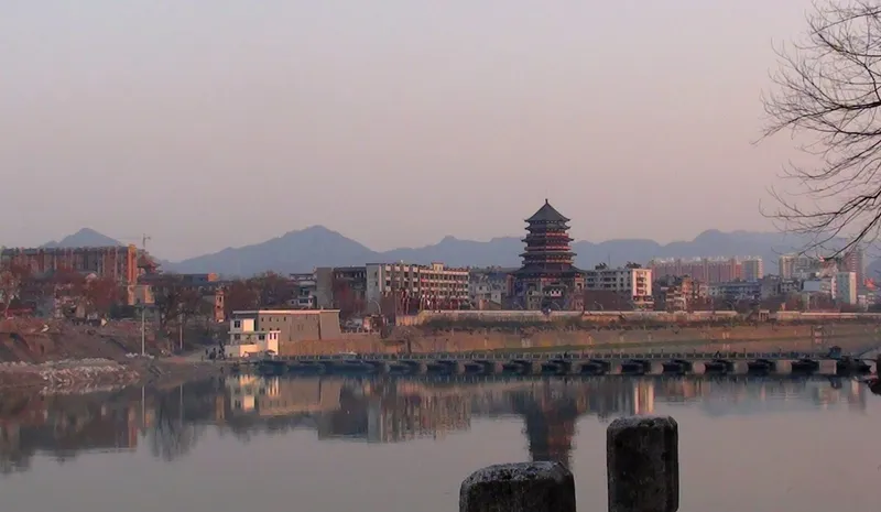 The Chang River waterfront and old kiln chimneys of Jingdezhen at dusk