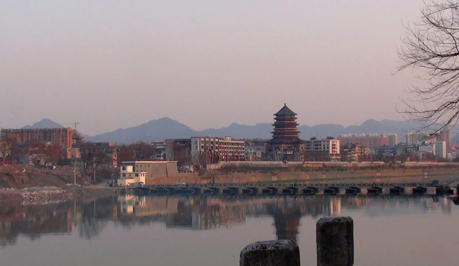 The Chang River waterfront and old kiln chimneys of Jingdezhen at dusk