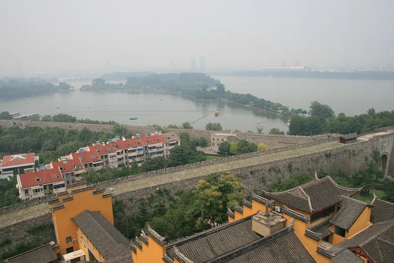 Sun Yat-sen Mausoleum's blue-tiled memorial hall seen from below, framed by trees on Purple Mountain in Nanjing