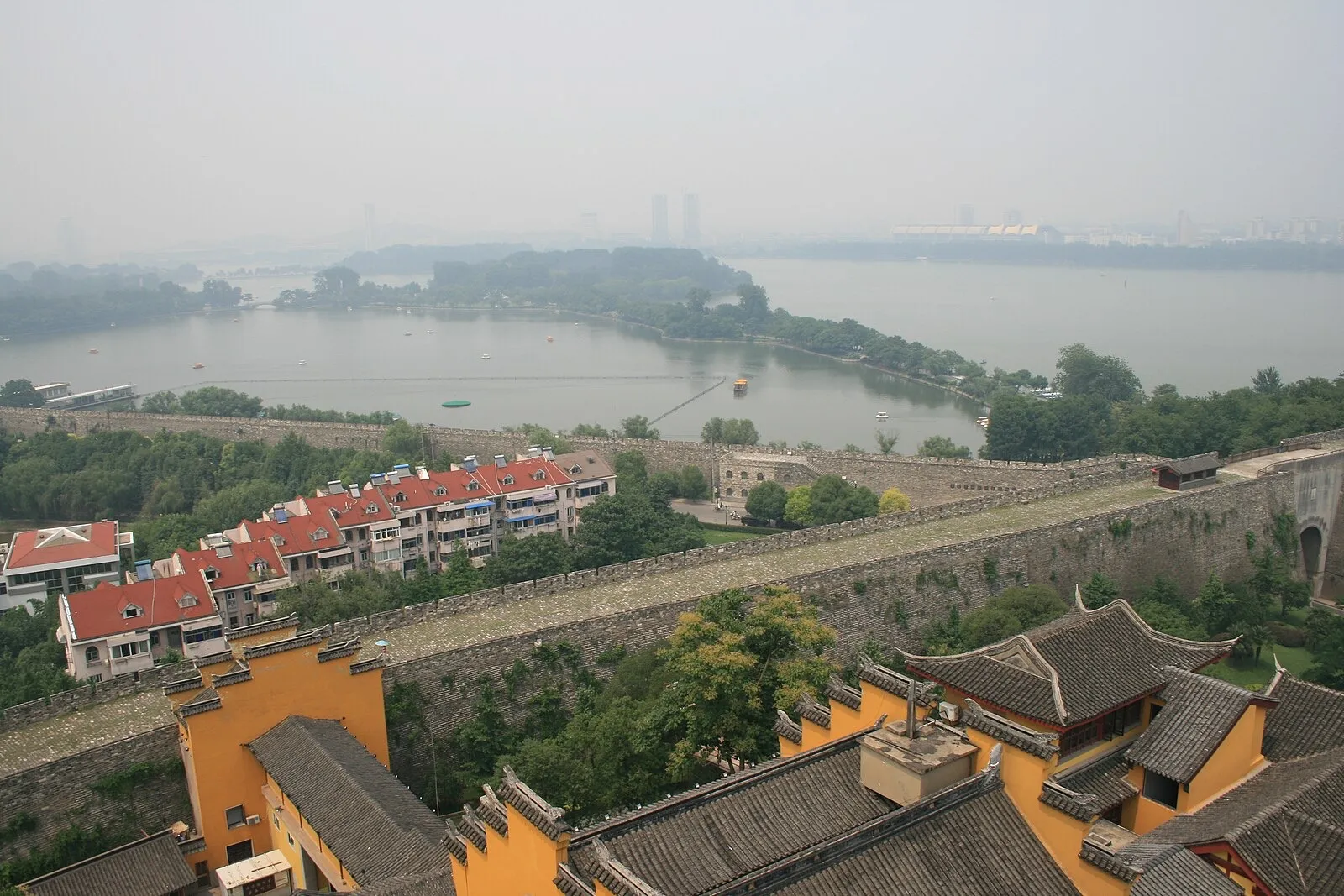 Sun Yat-sen Mausoleum's blue-tiled memorial hall seen from below, framed by trees on Purple Mountain in Nanjing