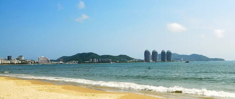 Sunset over Sanya Bay with the towers of Phoenix Island on the skyline
