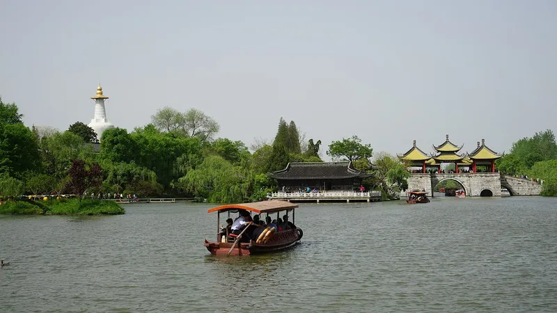 Five-Pavilion Bridge and the White Pagoda across the willow-lined water of Slender West Lake, Yangzhou